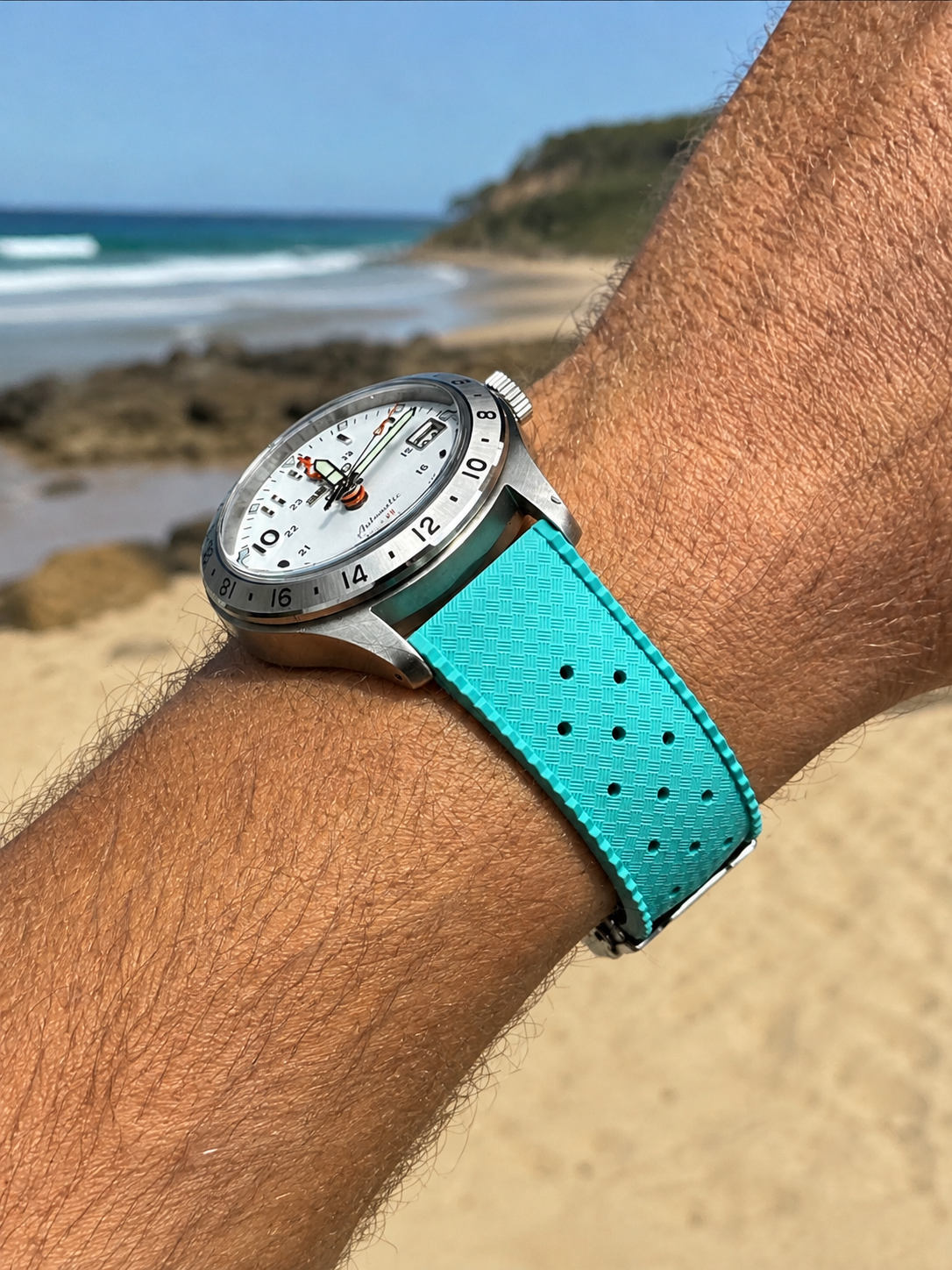 Turquoise FKM rubber Tropic watch strap with deployant clasp on wrist